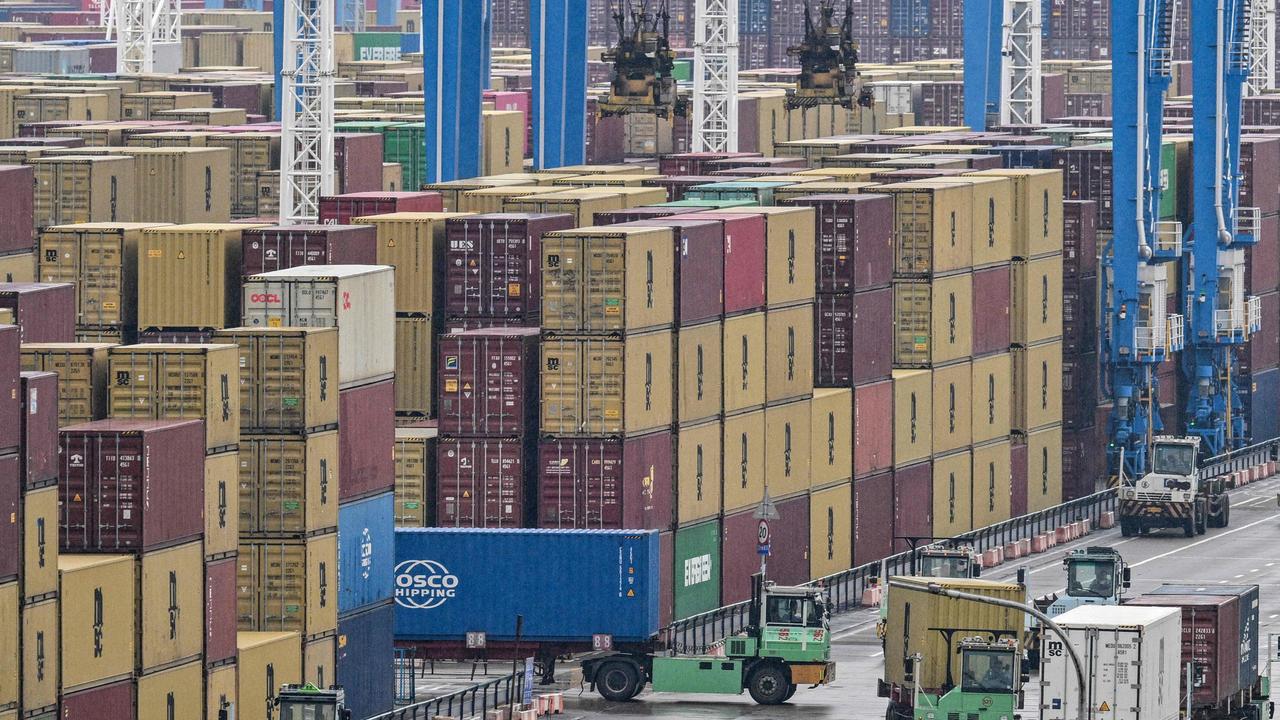 Trucks drive past containers at the Port of Ningbo-Zhoushan in Ningbo, in China's eastern Zhejiang Province. Picture: Hector Retamal/AFP