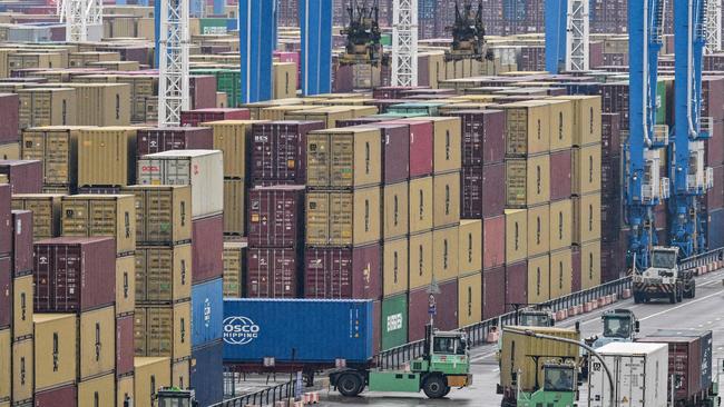 Trucks drive past containers at the Port of Ningbo-Zhoushan in Ningbo, in China's eastern Zhejiang Province. Picture: Hector Retamal/AFP