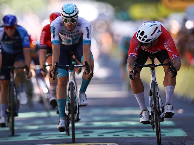 Team Jayco AlUla’s Dylan Groenewegen (right) throws for the line to win the Aussie team’s only stage. Picture: AFP