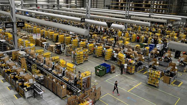 Amazon workers sort and pack items at the Amazon Fulfilment Centre in Peterborough, England. Picture: AFP