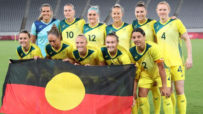 Matildas players with the Indigenous flag. Picture: AFP Images