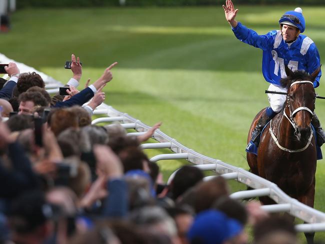 Hugh Bowman and Winx greet the fans on their returns to scale. Picture: Getty Images