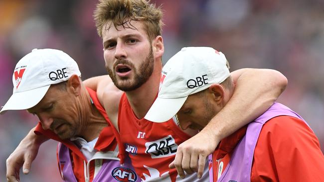 Unlucky Swan Alex Johnson is helped from the ground after sustaining his latest knee injury. Picture: AAP