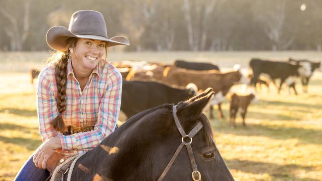 Tup riding her Australian Stock Horse named Done Deal with Hereford cattle.