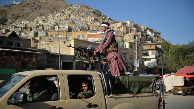 Taliban fighters patrol along a street in Kabul. Volunteer rescue workers say the group’s fighters are beheading their enemies. Picture: AFP)