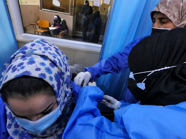 Iraqis get vaccinated with Chinese Sinopharm vaccine at a private nursing home in Baghdad. More than 25 counties are racing to use the vaccines China has sent them. Picture: AFP