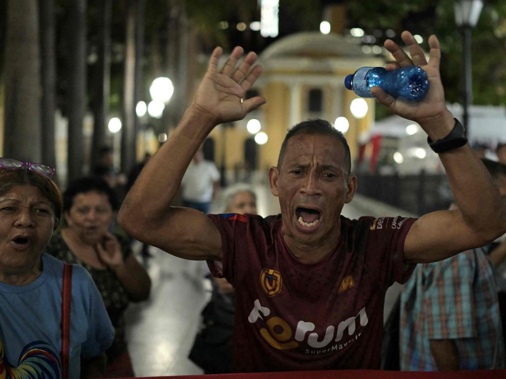 Supporters of Venezuelan President Nicolas Maduro shout slogans while waiting for the presidential election results.