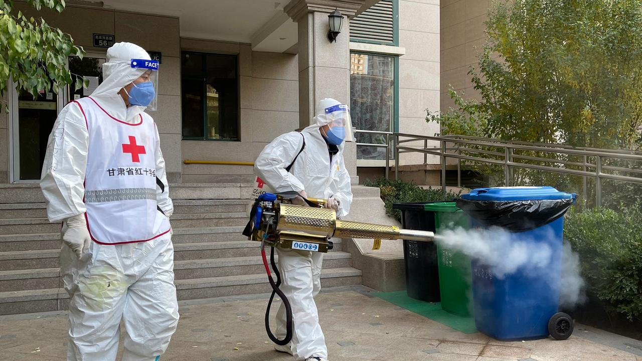 Workers disinfect a residential compound in Lanzhou, in China's northwestern Gansu province. Picture: AFP