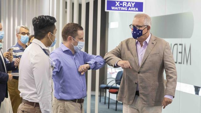 Mr Morrison greets Alex Hawke MP and Dr Jesse Li at Castle Hill Medical Centre in Sydney. Picture: NCA NewsWire /Jenny Evans