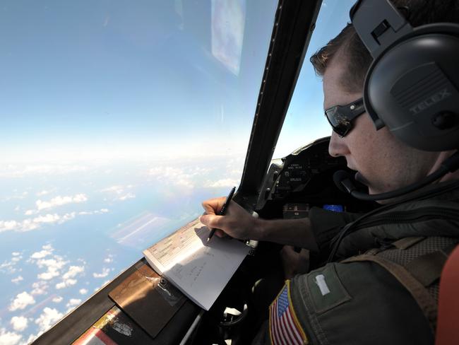 U.S. Navy LT JG Curtis Calabrese takes notes on board of a U.S. Navy Lockheed P-3C Orion patrol aircraft from Sigonella, Sicily, Sunday, May 22, 2016, searching the area in the Mediterranean Sea where the Egyptair flight 804 en route from Paris to Cairo went missing on May 19. Search crews found floating human remains, luggage and seats from the doomed EgyptAir jetliner Friday but face a potentially more complex task in locating bigger pieces of wreckage and the black boxes vital to determining why the plane plunged into the Mediterranean. (AP Photo/Salvatore Cavalli)