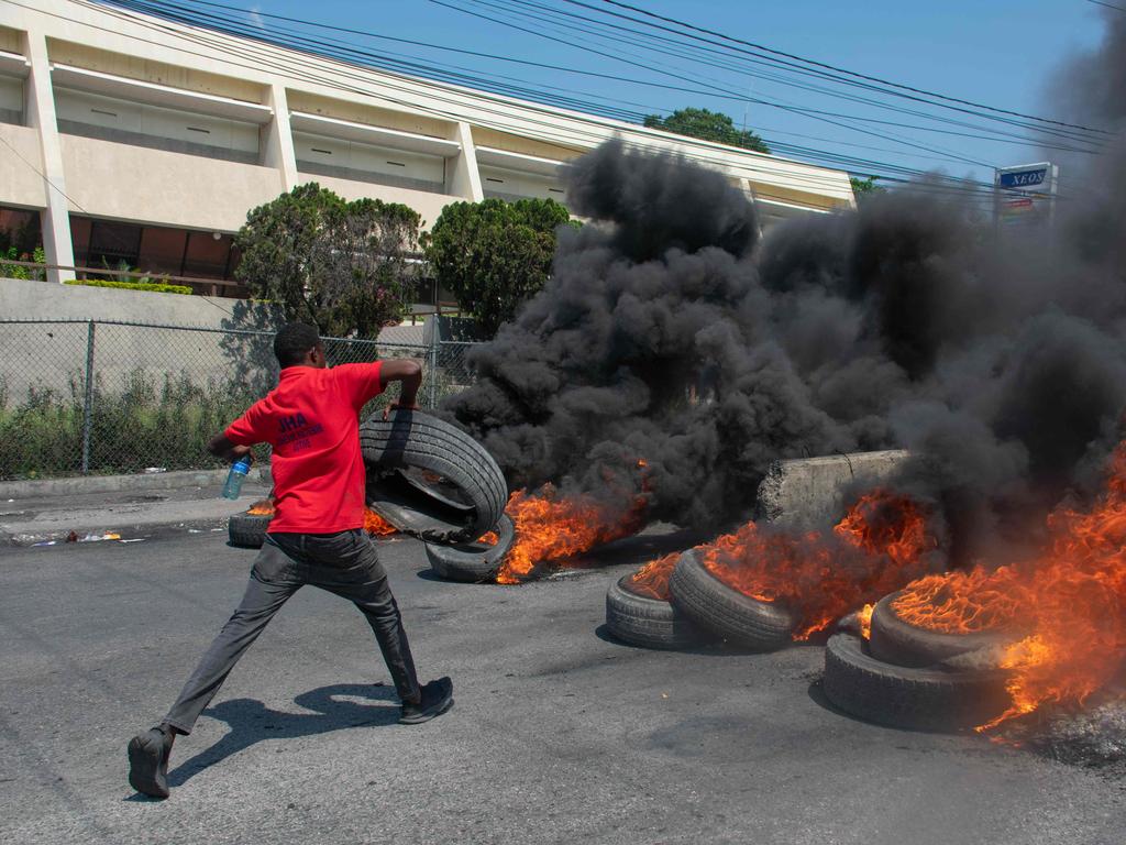 A protester burns tires during a demonstration following the resignation of its Prime Minister Ariel Henry.