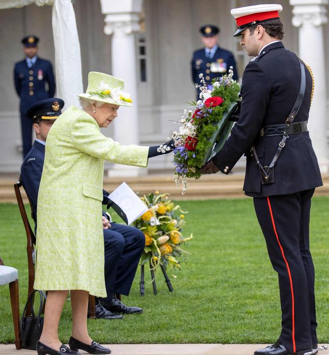 The monarch’s equerry prepares to lay a wreath on her behalf during the service. Picture: Steve Reigate / Pool / AFP