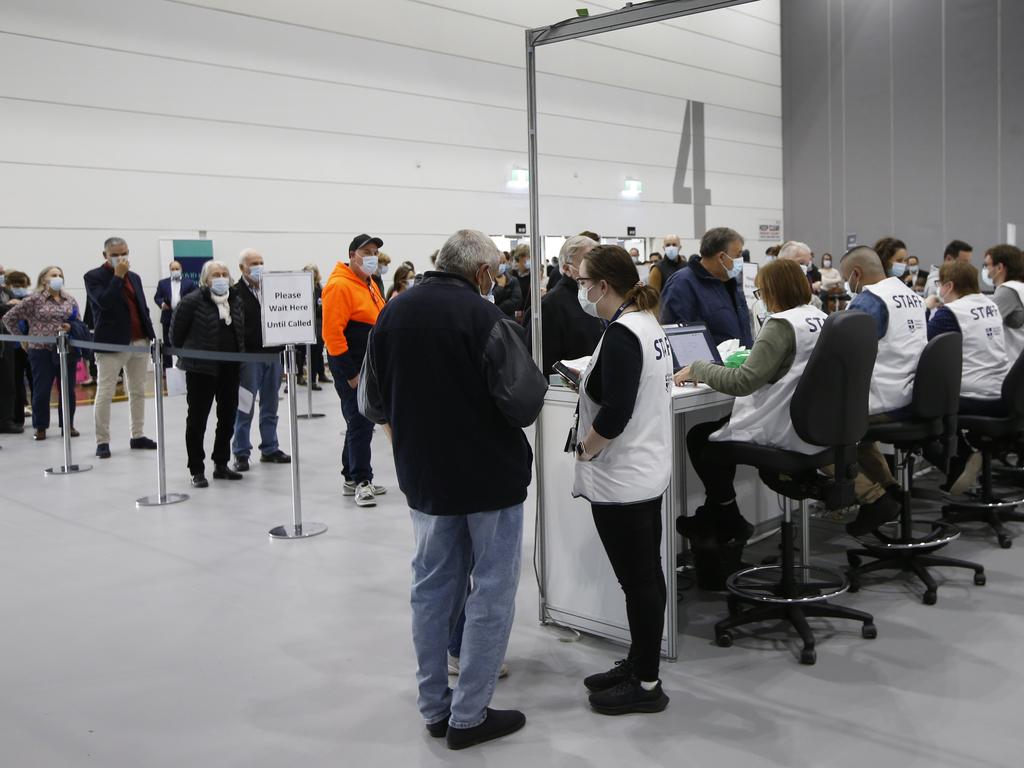 Crowds flock to vaccine hubs in Melbourne to get the jab after the COVID lockdown was announced. Royal Melbourne Hospital staff work flat out to cater for the sudden influx of people. Picture: David Caird