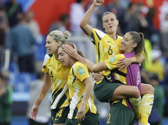 Australia's Chloe Logarzo, top, celebrates with a teammate at the end of the Women's World Cup Group C soccer match between Australia and Brazil at Stade de la Mosson in Montpellier, France, Thursday, June 13, 2019. Australia defeated Brazil 3-2. (AP Photo/Claude Paris)