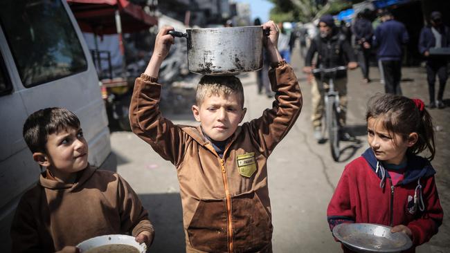 Young Palestinians hed to a food distribution point in Khan Younis. Picture: AFP