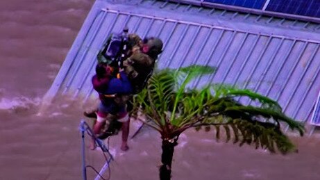 Emergency services have faced mishap on a Lismore roof while becoming entangled on an aerial in an attempt to winch members of the public to safety. Picture: ABC News