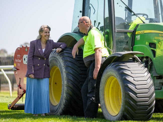 Kylie Rogers chats with groundsmen Shane at Flemington. Picture: Jason Edwards