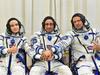 This handout photo taken and released on October 5, 2021 by Russian Space Agency Roscosmos shows Russian crew members, cosmonaut Anton Shkaplerov (C), actress Yulia Peresild (L) and film director Klim Shipenko, shaking hands as their spacesuits are tested prior to the launch onboard the Soyuz MS-19 spacecraft at the Russian-leased Baikonur cosmodrome. - A Russian actress and director arrived at the International Space Station (ISS) on October 5, 2021 to begin a 12-day mission to make the first movie in orbit. The Russian crew is set to beat a Hollywood project that was announced last year by "Mission Impossible" star Tom Cruise together with NASA and Elon Musk's SpaceX. (Photo by Andrey SHELEPIN / Russian Space Agency Roscosmos / AFP) / RESTRICTED TO EDITORIAL USE - MANDATORY CREDIT "AFP PHOTO/ RUSSIAN SPACE AGENCY ROSCOSMOS" - NO MARKETING - NO ADVERTISING CAMPAIGNS - DISTRIBUTED AS A SERVICE TO CLIENTS