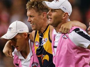 PERTH, WESTERN AUSTRALIA - APRIL 13:  Sam Mitchell of the Eagles is assisted off the field during the round four AFL match between the West Coast Eagles and the Sydney Swans at Domain Stadium on April 13, 2017 in Perth, Australia.  (Photo by Will Russell/AFL Media/Getty Images)