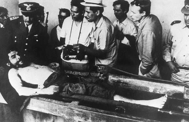 This picture taken on October 10, 1967 shows the body of Argentine-born legendary revolutionary figure Ernesto "Che" Guevara surrounded by Bolivian army officers and journalists, as it is displayed in a makeshift morgue in Vallegrande, Bolivia, a day after he was executed.