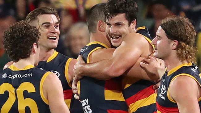 ADELAIDE, AUSTRALIA - JULY 30: Darcy Fogarty of the Crows celebrates a goal with team mates during the 2022 AFL Round 20 match between the Adelaide Crows and the Carlton Blues at the Adelaide Oval on July 30, 2022 in Adelaide, Australia. (Photo by Sarah Reed/AFL Photos via Getty Images)
