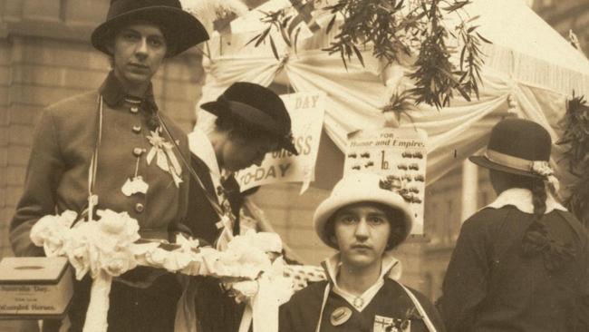 History Olive Bridgwater and her sister Doris outside the Department of Lands building in Bridge Street in Sydney during World War 1, fundraising for Australia Day, 30 July 1915