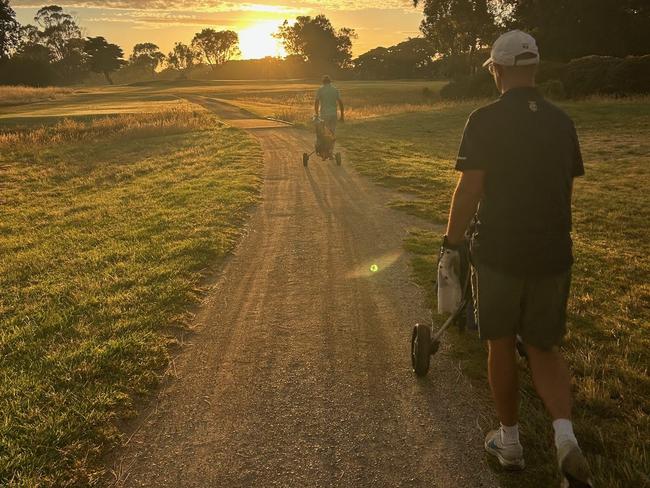 Andy Maher walking into the sunrise at the fourth hole at Portarlington’s The Longest Day. Picture: Supplied