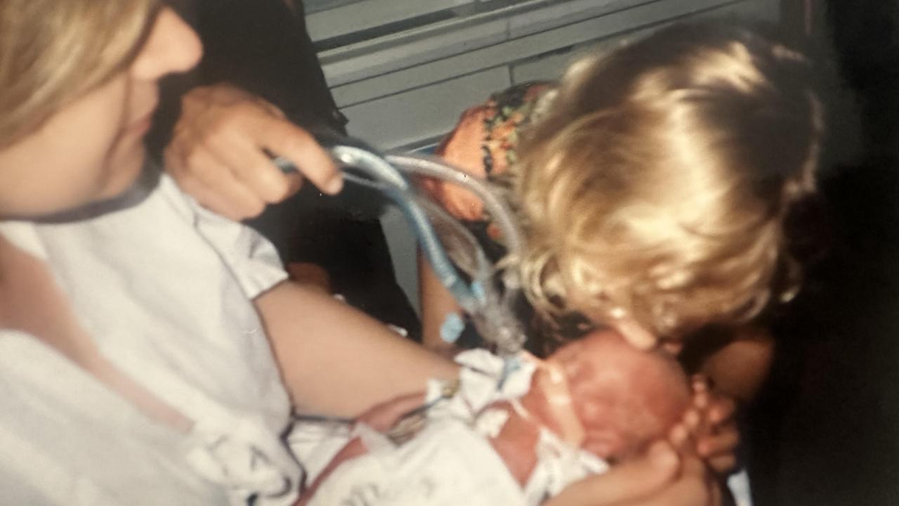 Angela Falkenberg with her two precious children, Elizabeth and baby James who was born at 23 weeks weighing 720g. Picture: Supplied