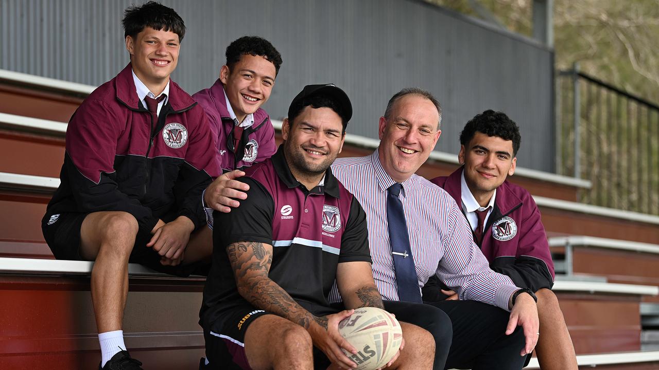 Former NRL champion Issac Luke with Year 11 students (L-R) Hayden Watson, Adaquix Luke and Javon Andrews, with school principal Marcus Jones. Picture: Lyndon Mechielsen/Courier Mail