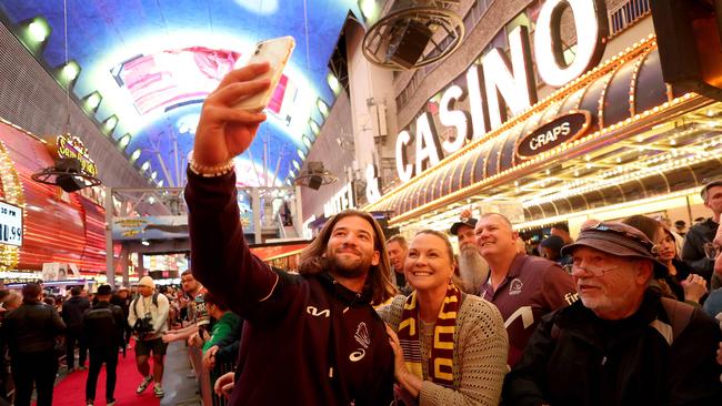 Pat Carrigan of the Brisbane Broncos takes a selfie with fans during the NRL season launch at Fremont Street Experience in 2024. Picture: Getty Images via AFP