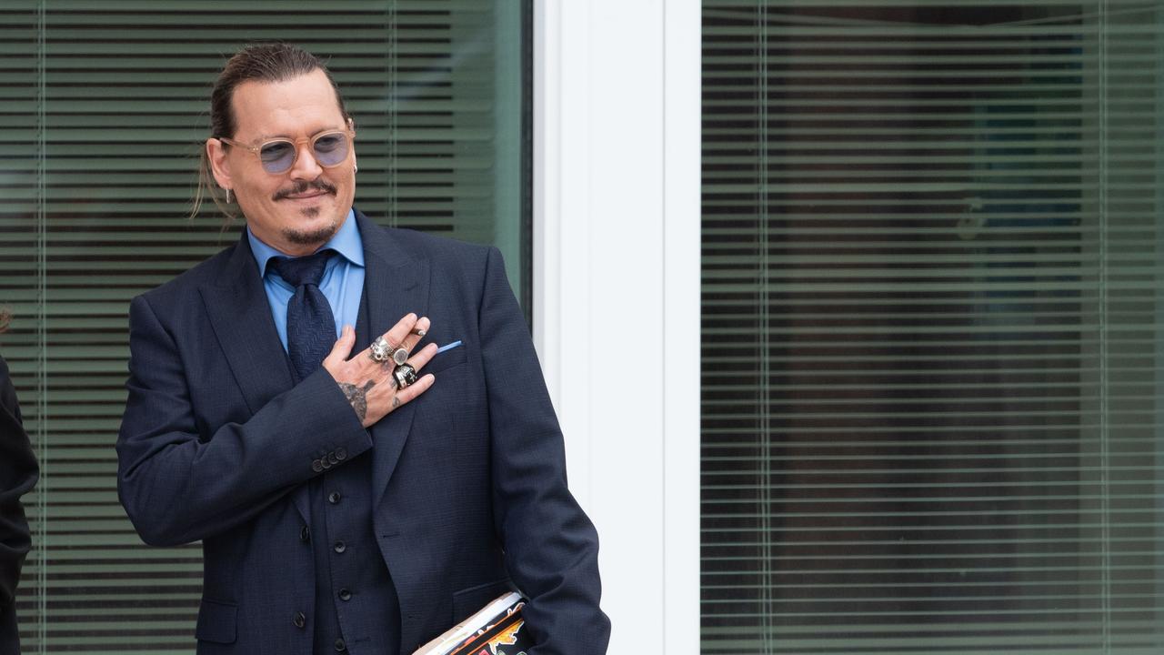 Johnny Depp gestures to fans during a recess outside court during the trial. (Photo by Cliff Owen/Consolidated News Pictures/Getty Images)