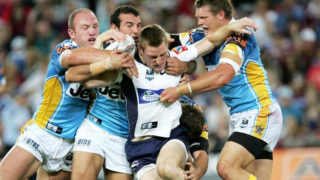 Brisbane's Brent Tate gang tackled by from left Luke Bailey, Anthony Lanfranchi and Michael Henderson (AAP Image/Colin Whelan/Action Photographics)