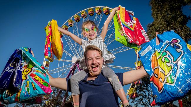 Royal Melbourne Show. Josh Carey and his niece Olivia Kolaitis, 7, load up with showbags. Picture: Jake Nowakowski