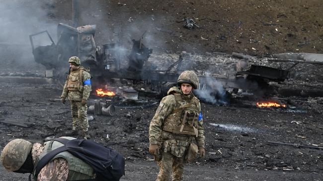 Ukrainian service members collect unexploded shells in Kyiv. Picture: AFP