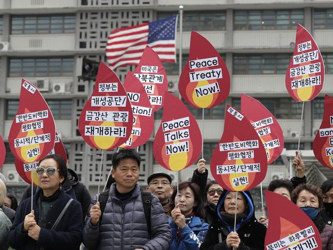 Protesters hold signs during a rally demanding the denuclearization of the Korean Peninsula and peace treaty near the U.S. embassy in Seoul, South Korea, Thursday, March 21, 2019. The Korean Peninsula remains in a technical state of war because the 1950-53 Korean War ended with an armistice, not a peace treaty. More than 20 protesters participated at a rally and also demanding the end the Korean War and to stop the sanction on North Korea. The letters read 