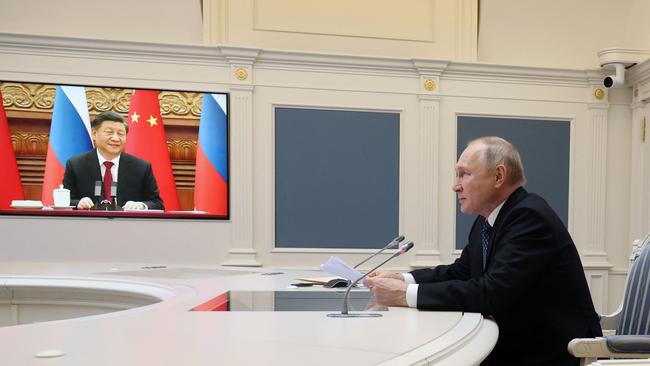 Russian President Vladimir Putin meeting with Chinese President Xi Jinping via a video link. Photo by Mikhail Klimentyev / AFP