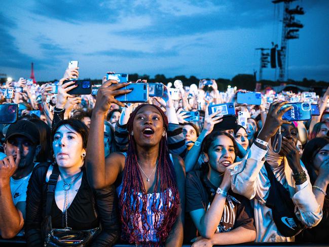 Festival-goers take videos and photographs during the Lollapalooza event at the Hippodrome de Longchamp in Paris. Picture: Julie Sebadelha / AFP