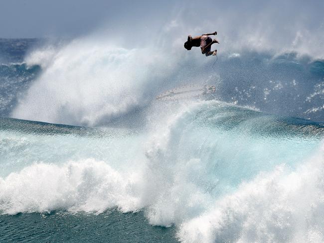 Surfers are seen at Snapper Rocks on the Gold Coast, Thursday, February 21, 2019. Huge swells and high tides are set to pummel south-east Queensland beaches over the coming days as Cyclone Oma tracks towards the Queensland coast (AAP Image/Dave Hunt) NO ARCHIVING