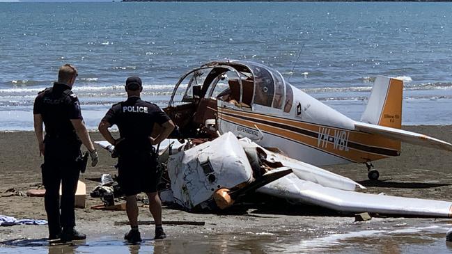 Members of Gerry’s family looked on at police quickly gathered evidence from a fatal plane crash at Ball Bay, north of Mackay, on Christmas Eve 2021. Photo: Janessa Ekert