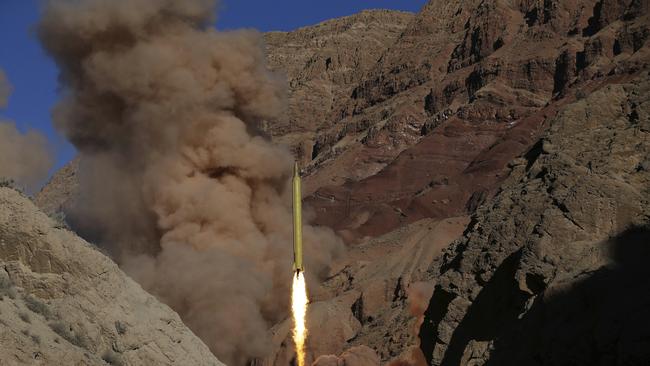 FILE - In this March 9, 2016 file photo obtained from the Iranian Fars News Agency, a Qadr H long-range ballistic surface-to-surface missile is fired by Iran's powerful Revolutionary Guard during a maneuver in an undisclosed location in Iran. President Donald Trump is weighing whether to pull the U.S. out of Iran's nuclear deal, a 2015 agreement that capped over a decade of hostility between Tehran and the West over its atomic program. (AP Photo/Fars News Agency, Omid Vahabzadeh, File)