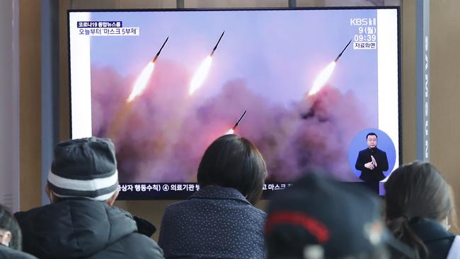 People at the Seoul Railway Station watch file images of a North Korea's missile launch on Monday. Picture: AP