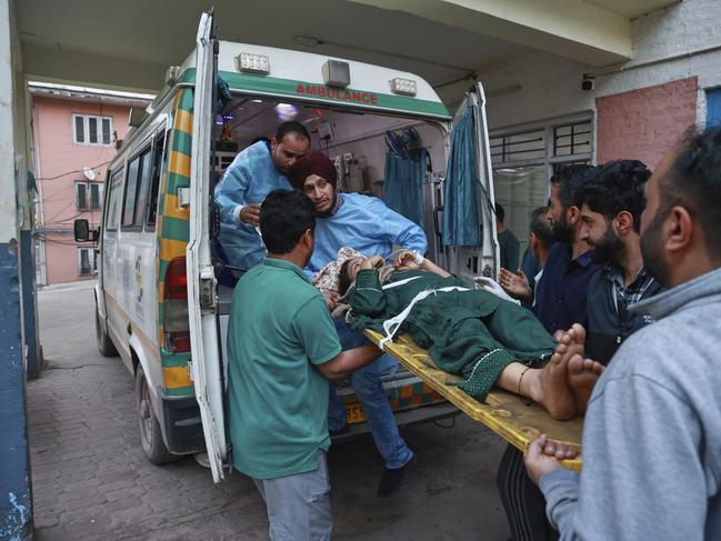 A woman living in a village near the Line of control between India and Pakistan and got injured in Pakistani shelling is brought to a hospital in Uri, in Indian controlled Kashmir. Picture: AP Photo