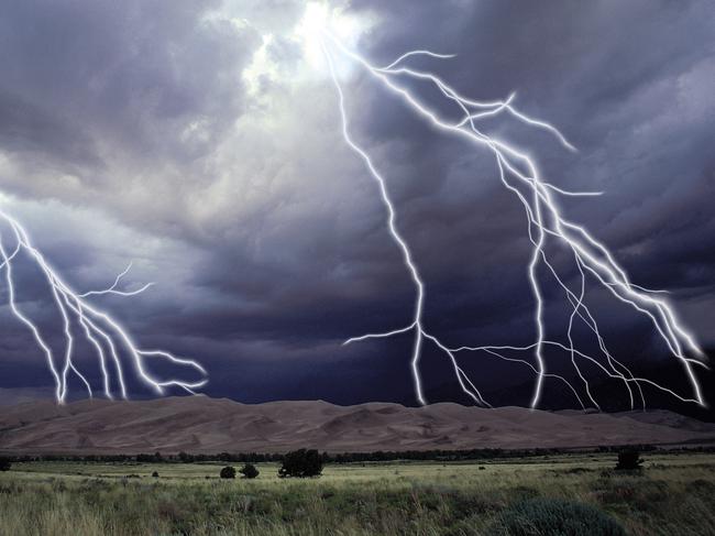 Landscape with lightning bolts from storm. Generic image.