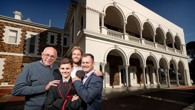 Celebrating Rostrevor’s 95-year tradition: Brother Michael Coughlin is pictured with old scholar Port Adelaide’s Jack Hombsch, current student Olly Piro and former student John Piro. Picture: Dylan Coker