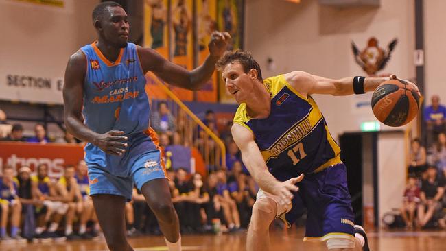 Heat's Peter Crawford is guarded by Marlins Kuany Kuany. Picture: Zak Simmonds.