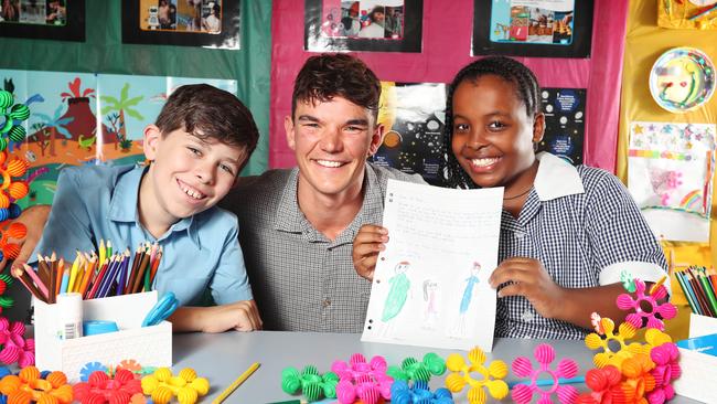 Mr Will Madden and his St Brendan's Primary School students Max Rinder and Shalom Sengogo, both 10, with the letter they wrote him. Picture Rebecca Michael.