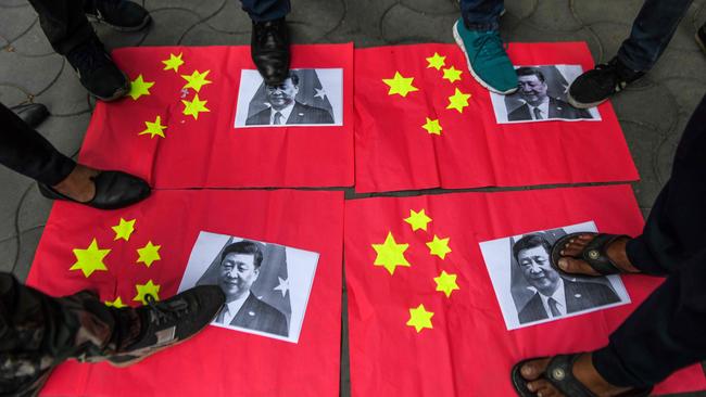 Activists stamp on Chinese flags and posters of Chinese President Xi Jinping during an anti-China protest after a violent border brawl between India and China this month.