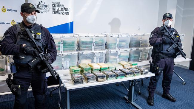 Australian Federal Police officers guard the drugs during a press conference. Picture: Tom Huntley.