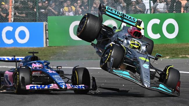 Mercedes' British driver Lewis Hamilton (R) collides with Alpine's Spanish driver Fernando Alonso