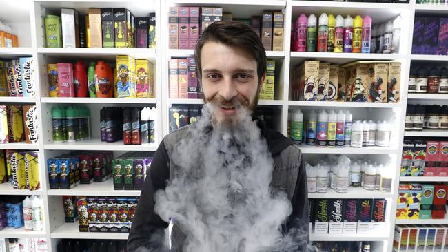 Hayden Holland works at Vaper Choice in Surry Hills where they sell more than 400 vape flavours. Picture: Toby Zerna